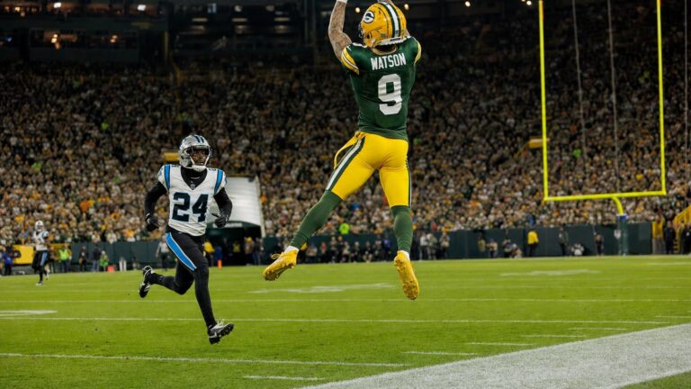 Green Bay Packers wide receiver Christian Watson making a leaping catch at Lambeau Field