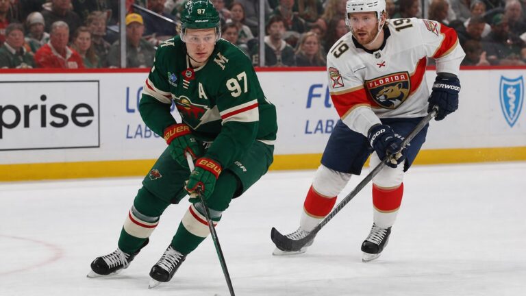 Kirill Kaprizov of the Minnesota Wild and Matthew Tkachuk of the Florida Panthers battle for the puck